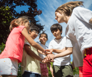 Kids shaking hands in a circle