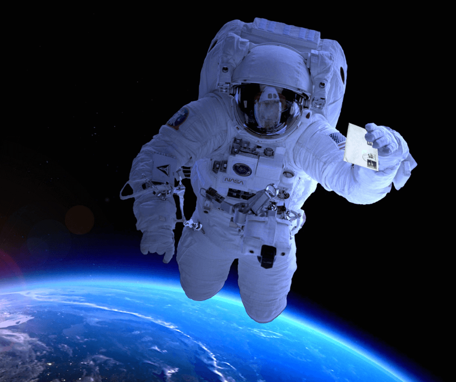 Astronaut floating in space holding a letter in one hand