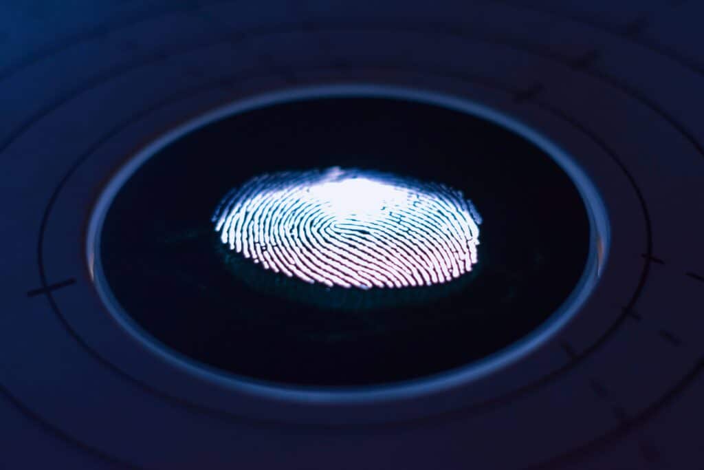 Finger print illuminated from below on a round black and white light.