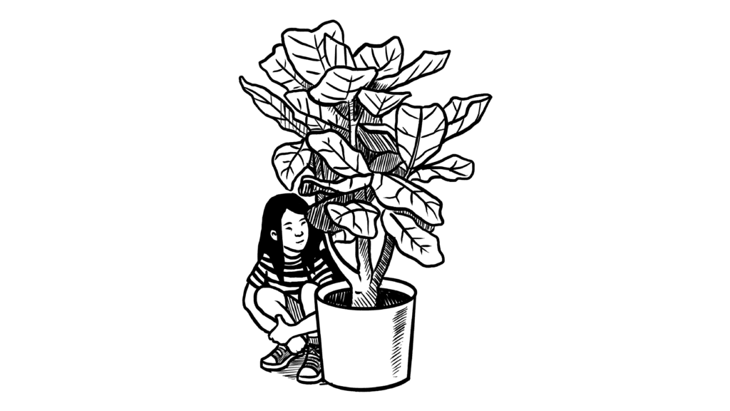 girl hiding behind a large plant