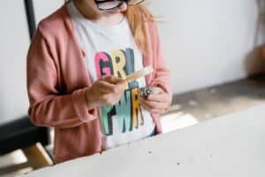Student looking through a magnifying glass.