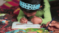 Gif of child coloring in a coloring book