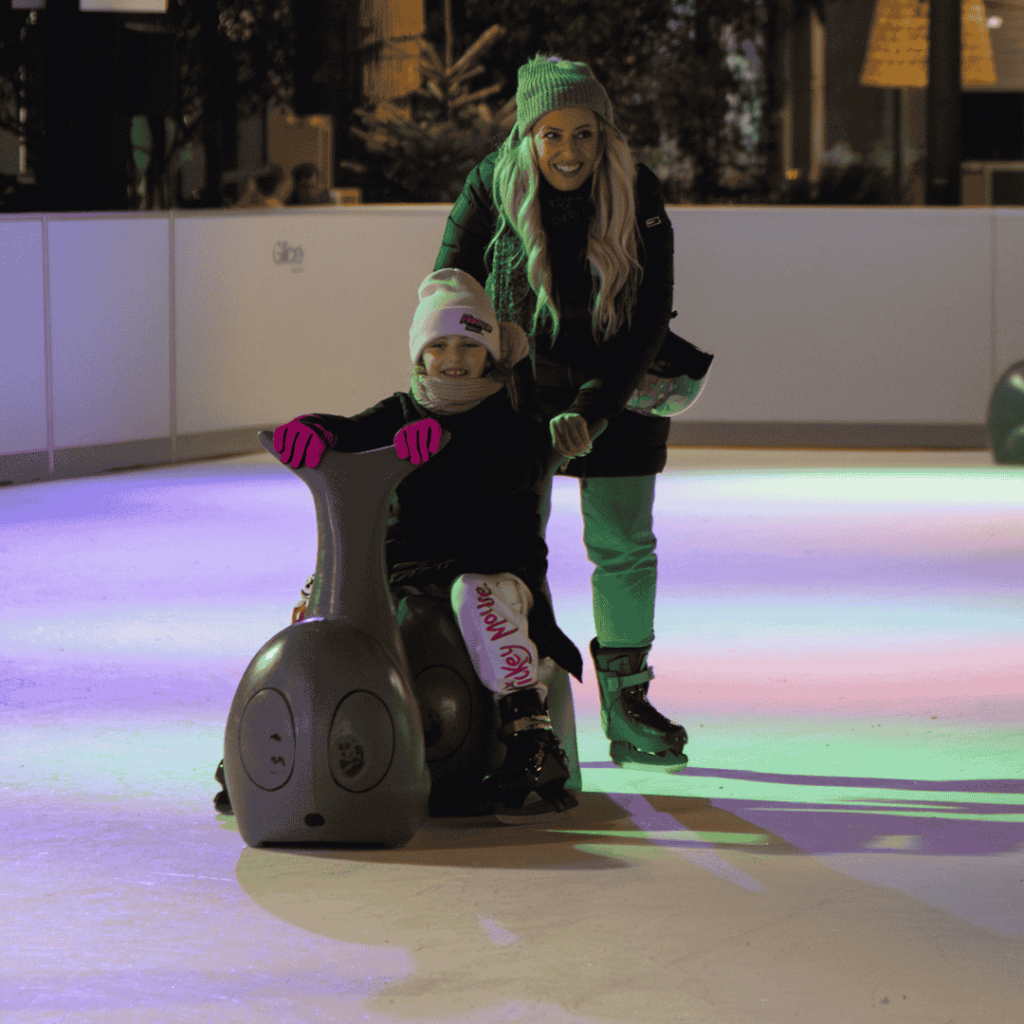 Mom and child skating at indoor rink
