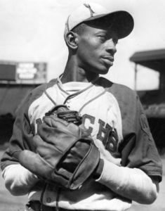 black and white image of Leroy Robert “Satchel” Paige in baseball gear