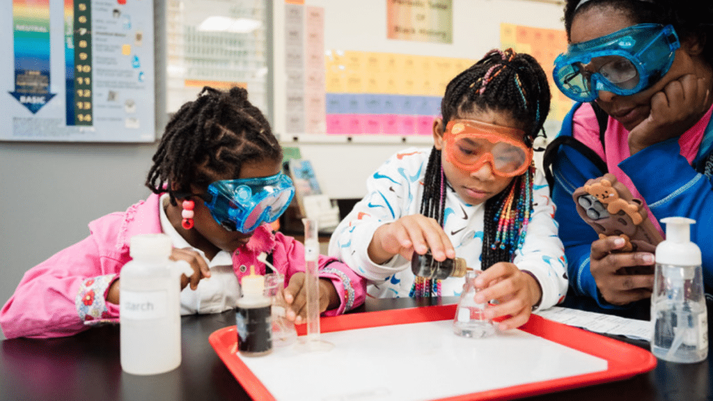 Picture of two girls in goggles doing an experiment at Black Community Science Night