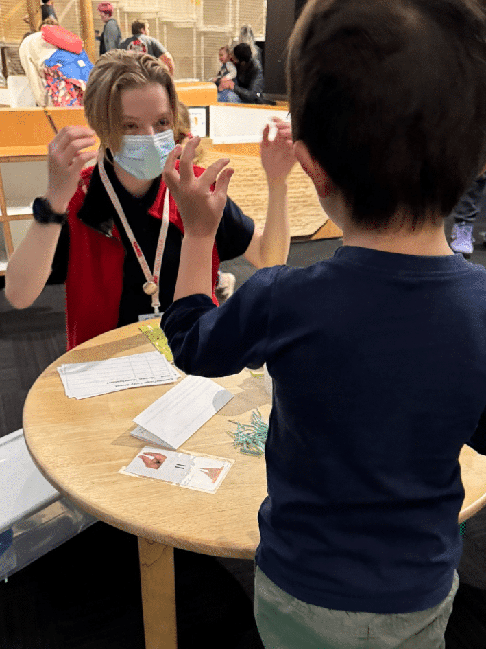 Volunteer with a young learner in the Science Playground