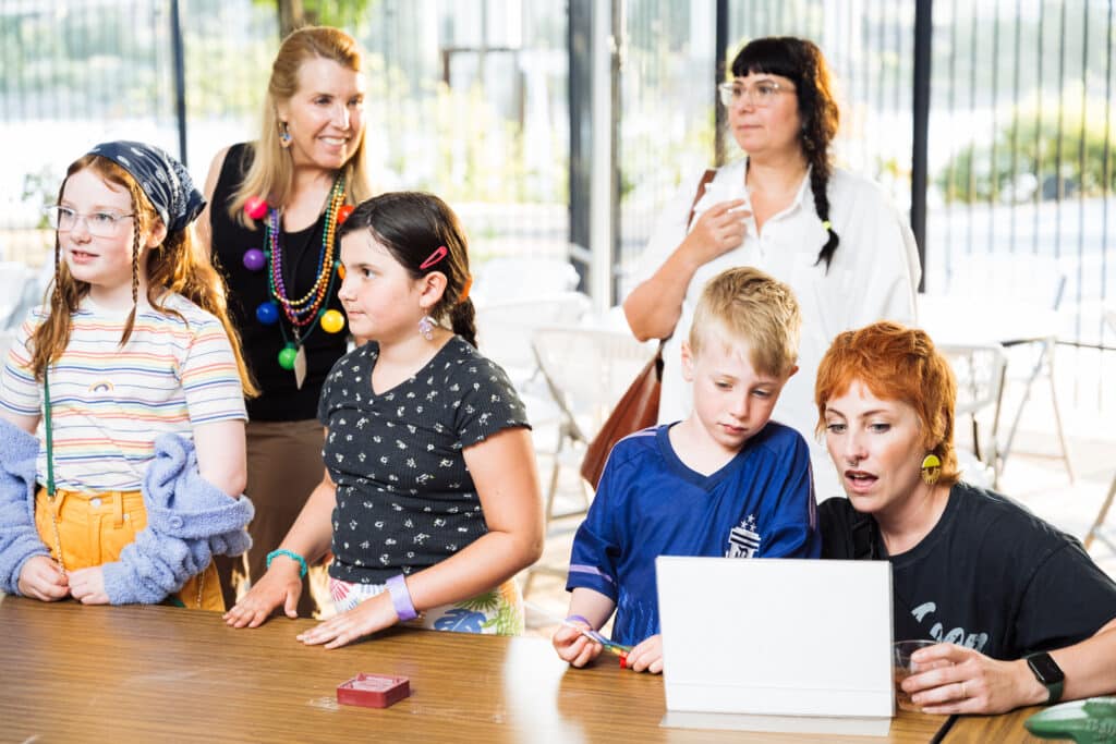 A group of kids do a science demo at Pride at the Museum