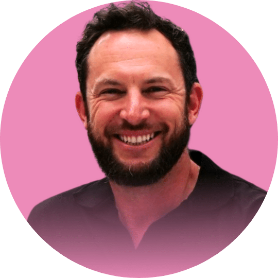 Headshot of a man with a black beard and a black polo shirt
