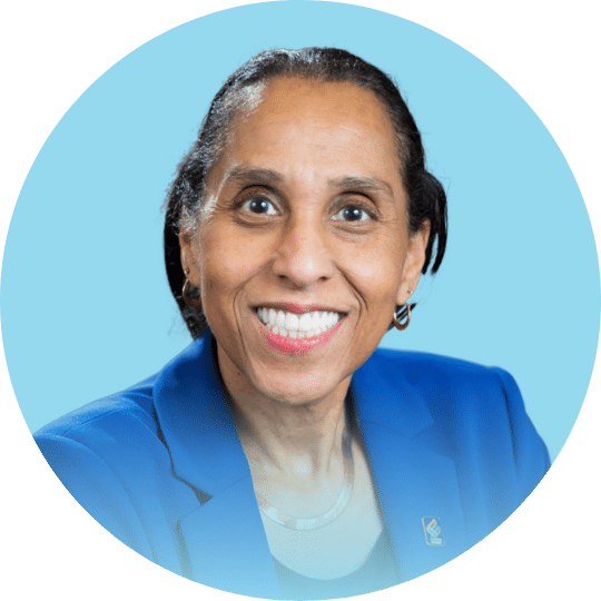 Headshot of a Woman with a blue blazer and slicked back hair