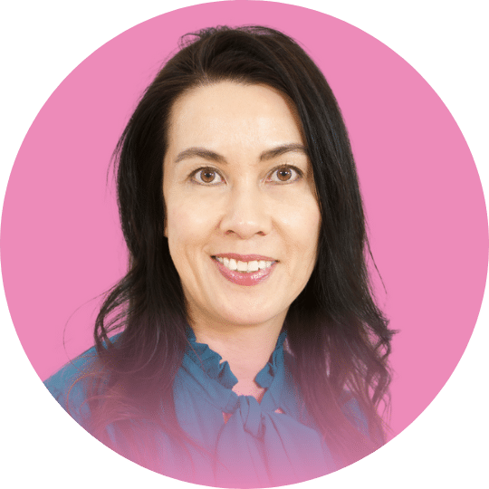 Headshot of a Woman with black hair and a blue top with a ribbon