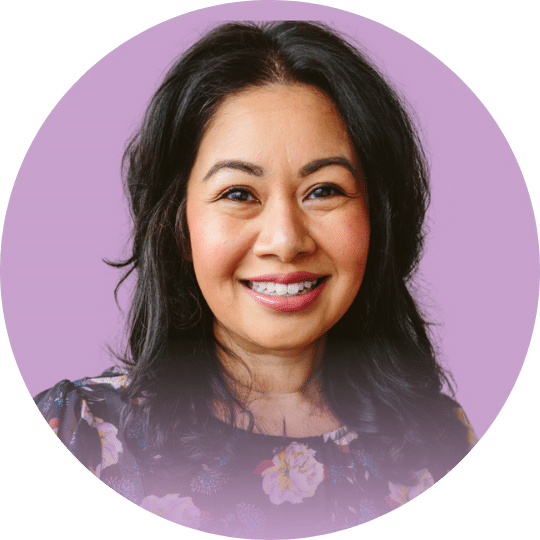 Headshot of a Woman with black hair and a floral top