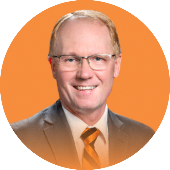 Headshot of a Man with glasses and an orange and black tie