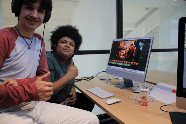 Two teens sitting at a desk in the teen tech center