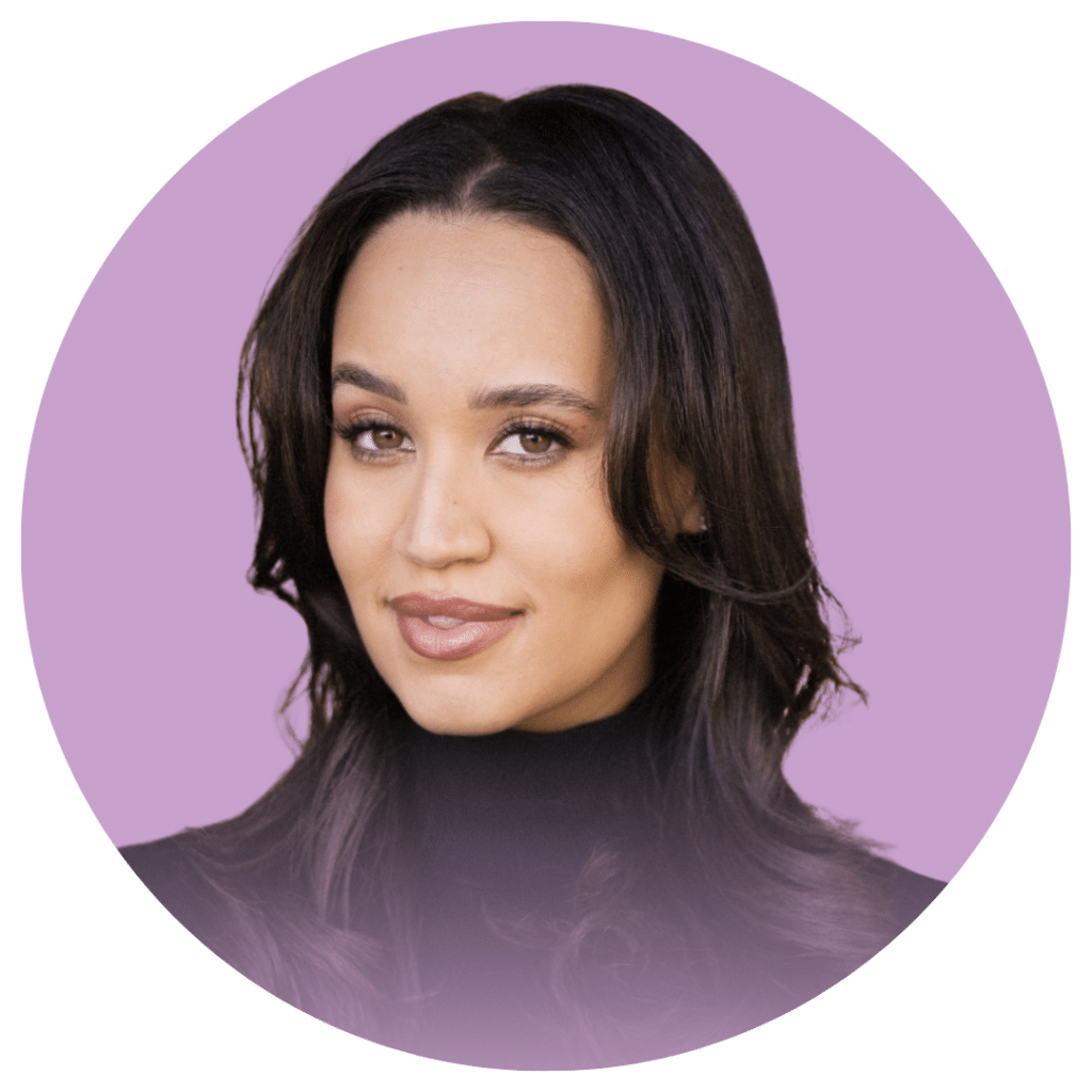 A headshot of a woman with a black turtleneck sweater. The background of the headshot is a lavender color called Holley.