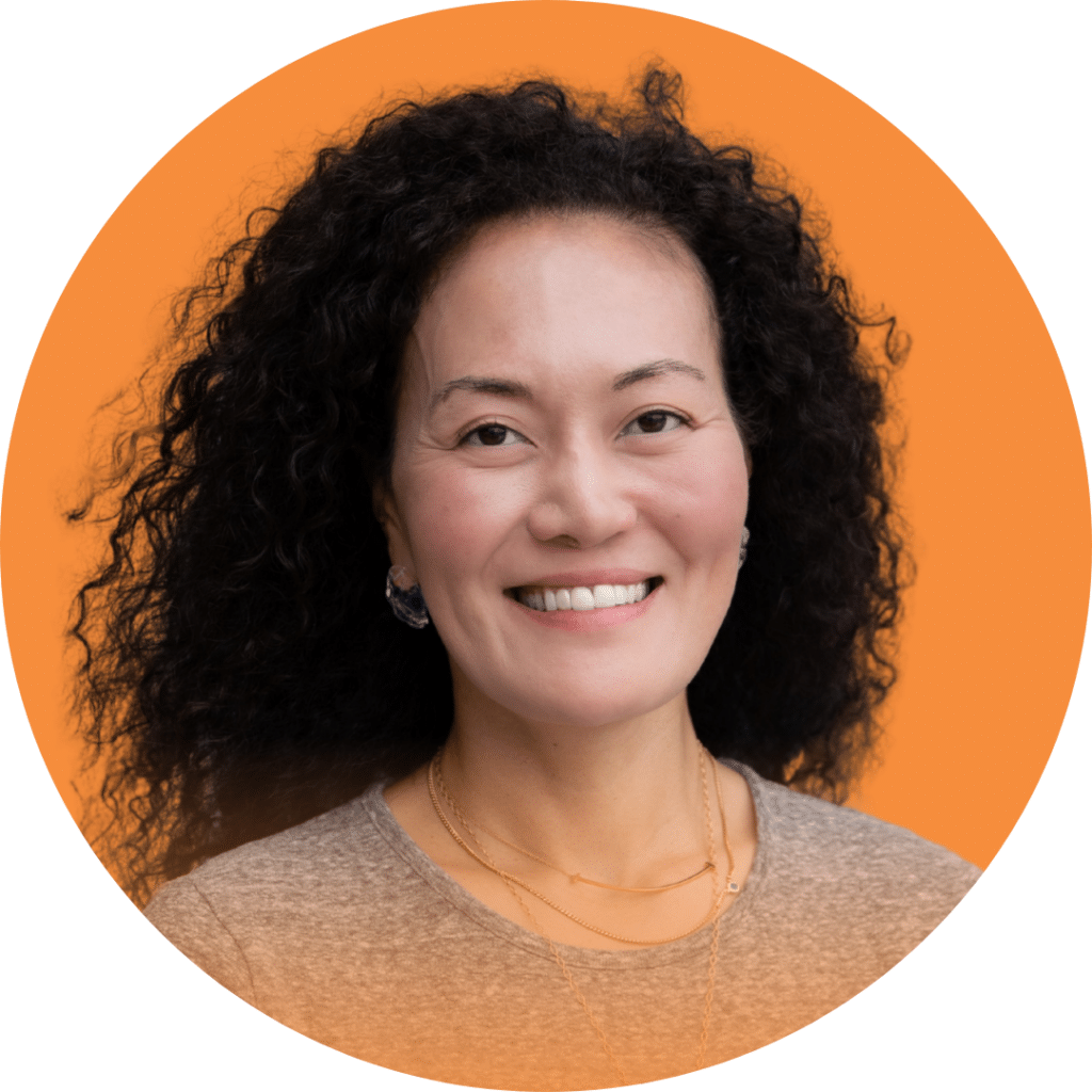A headshot of Michi Slick on an orange background