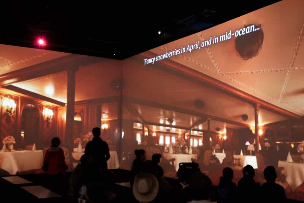 MeyerPro's immersive gallery in displays dining room in the Titanic, with tables set but empty. Text on the screen reeds "'Fancy strawberries in April, and in mid-ocean..."