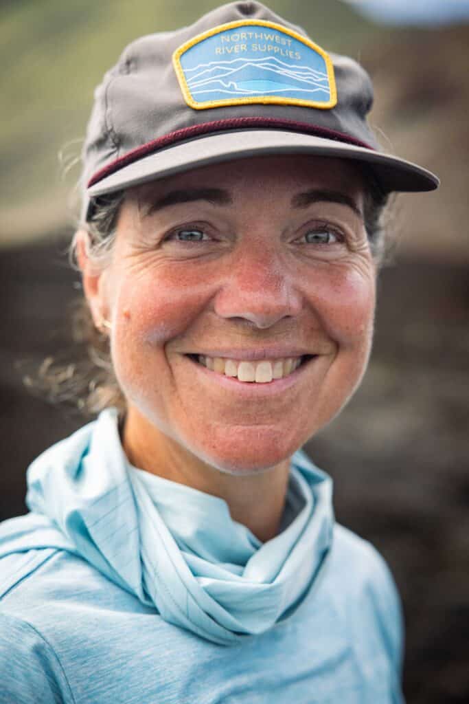 Christine Parent wearing a baseball cap and blue scarf